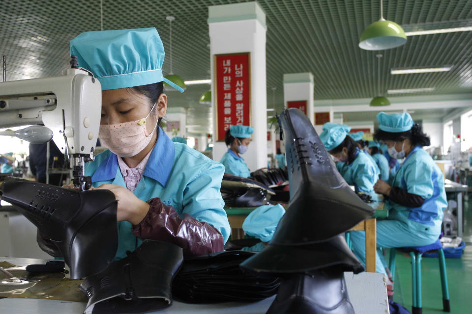 Workers make leather shoes at the Wonsan Leather Shoes Factory in Wonsan, Kangwon Province, North Korea, on Oct. 28, 2020. North Korea is staging an “80-day battle,” a propaganda-heavy productivity campaign meant to bolster its internal unity and report greater production in various industry sectors ahead of a ruling party congress in January. (AP Photo/Jon Chol Jin)