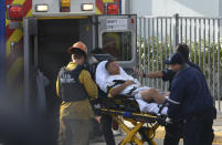 Medical personnel load an injured person into an ambulance outside Saugus High School in Santa Clarita, Calif., after a student gunman opened fire at the school on Thursday, Nov. 14, 2015. (Rick McClure via AP)