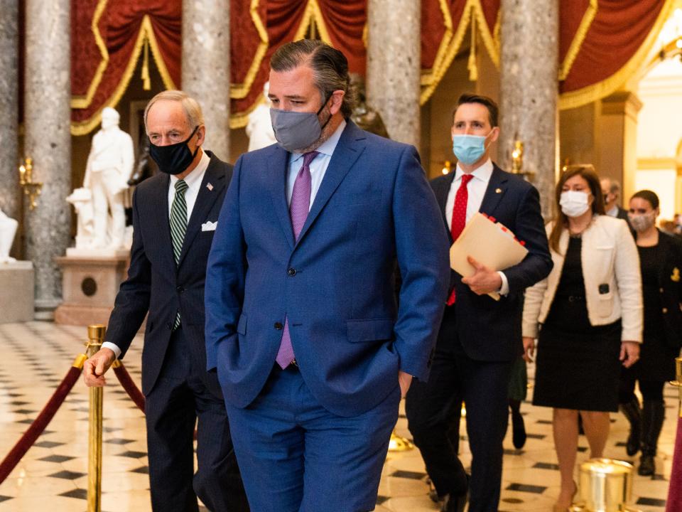 <p>Ted Cruz, front, followed by Josh Hawley, walk from the House Chamber following a Senate procession carrying boxes holding Electoral College votes to the House Chamber on Wednesday 6 January </p> ((Associated Press))