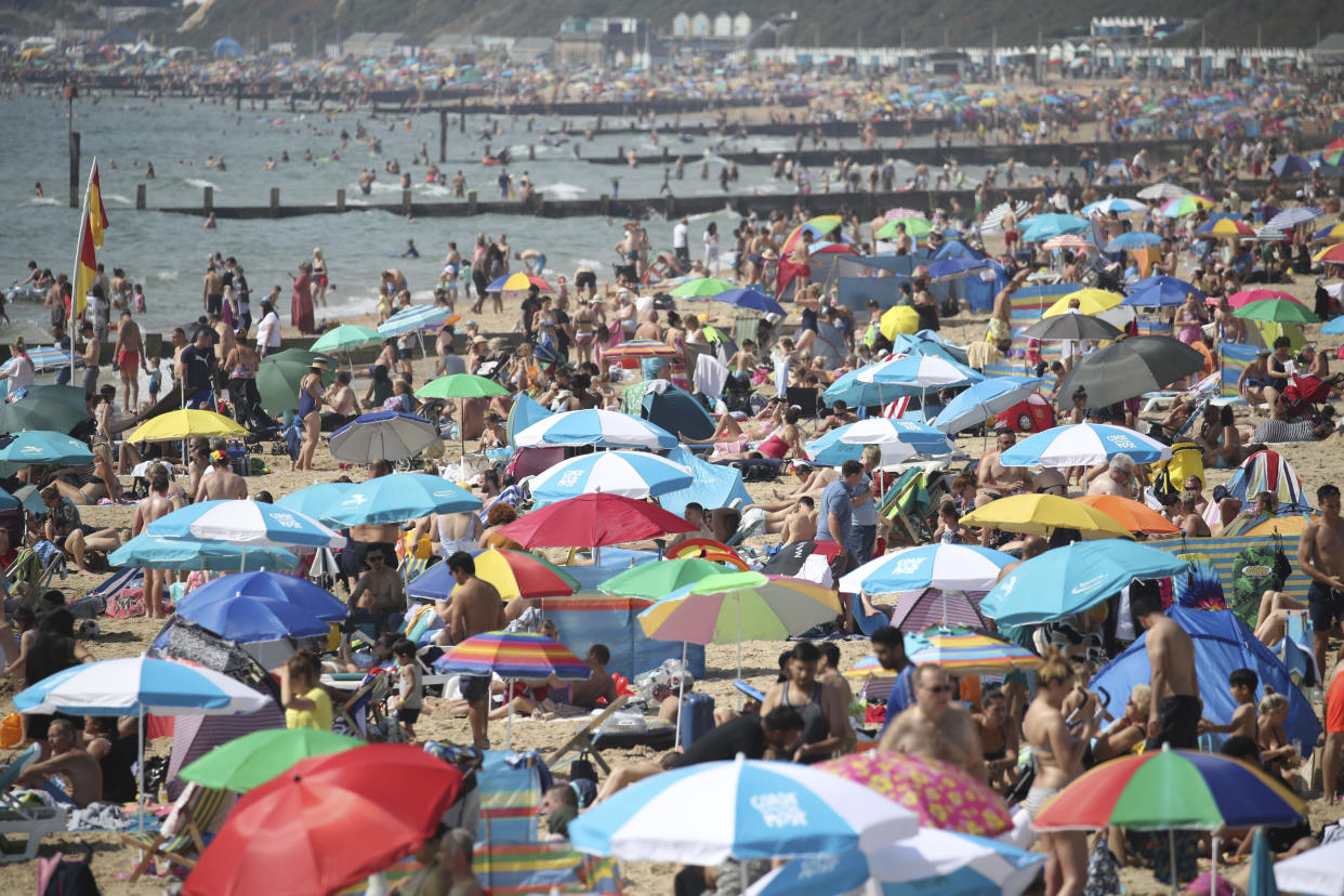 People enjoying the warm weather on Bournemouth beach, as a bank holiday heatwave will see most of Britain sizzling in sunshine with possible record temperatures, the Met Office has said. Saturday Aug, 24, 2019. |(|Andrew Matthews/PA via AP)