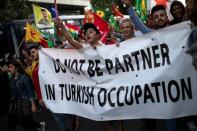 Kurds living in Greece and Greek protesters shout slogans during a demonstration against Turkey's military action in northeastern Syria, in Athens