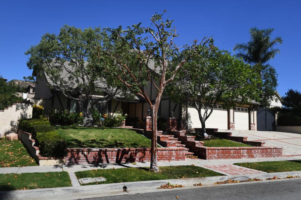 Trees stand tall in front of a Simi Valley house used as the exterior for the family home depicted in the 1982 film "Poltergeist."