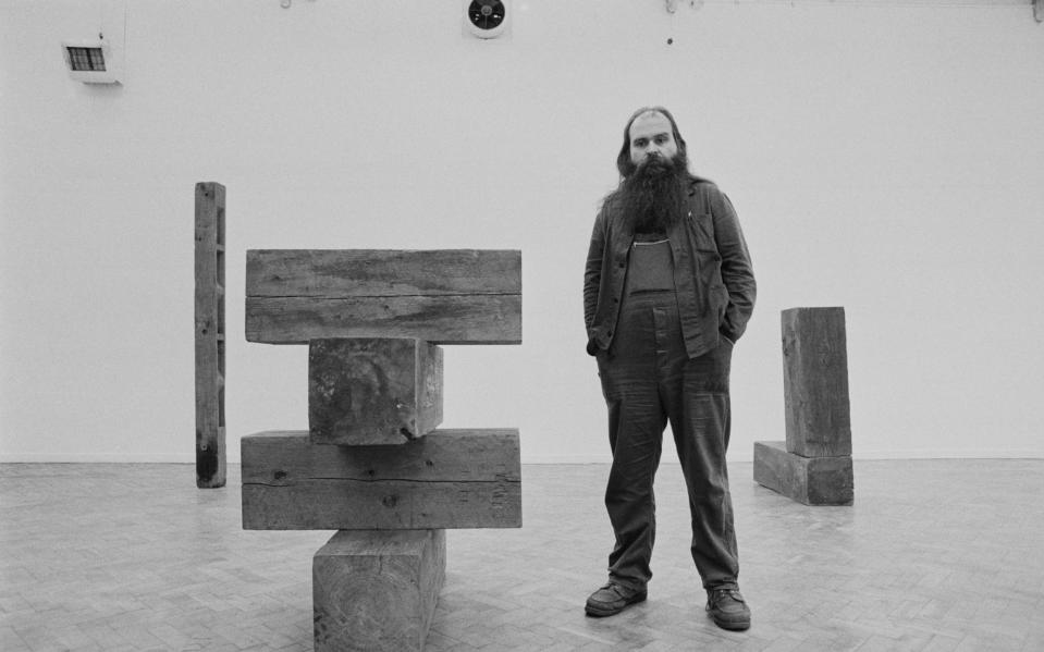 Carl Andre with one of his pieces at the Whitechapel Gallery in 1978