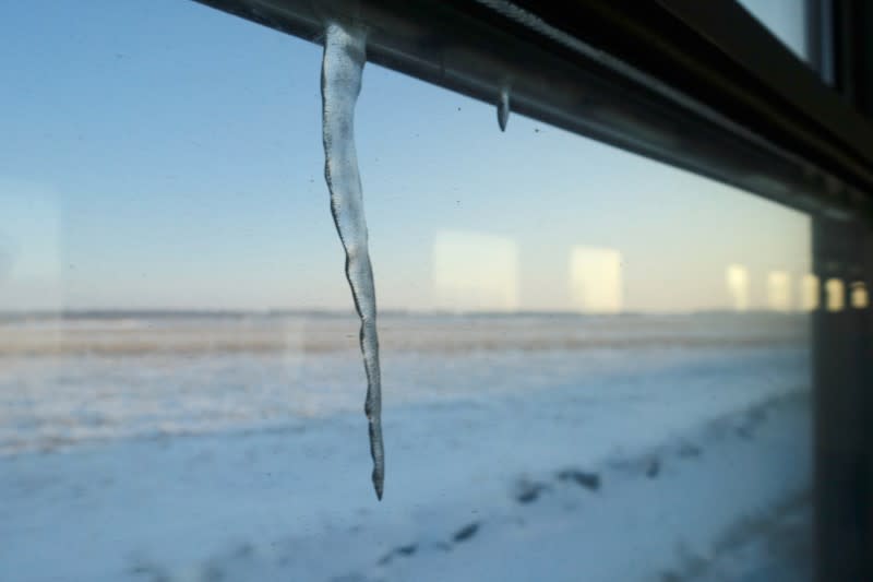 Icicle hangs off the window frame on a train heading to the coal-producing city of Hegang