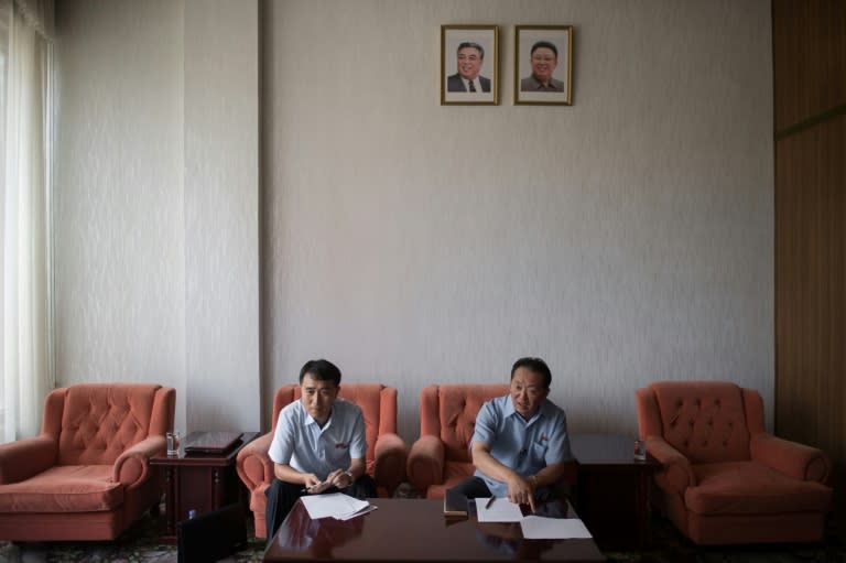 Han Chol-Su (R), vice director of the Wonsan Zone Development Corporation, and Ri Kyong Chol (L), section chief of Wonsan Zone Development Corporation, speak to AFP at the Koryo hotel in Pyongyang