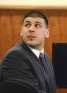 Former New England Patriots football player Aaron Hernandez sits during his murder trial at Bristol County Superior Court in Fall River, Massachusetts February 11, 2015. REUTERS/Ted Fitzgerald/Pool (UNITED STATES - Tags: CRIME LAW SPORT FOOTBALL)