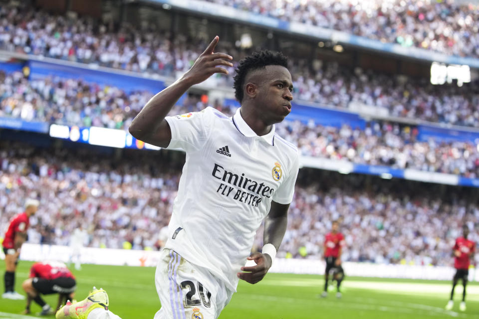 Real Madrid's Vinicius Junior, left, celebrates after scoring his side's 2nd goal during the Spanish La Liga soccer match between Real Madrid and Mallorca at the Santiago Bernabeu stadium in Madrid, Spain, Sunday, Sept. 11, 2022. (AP Photo/Manu Fernandez)