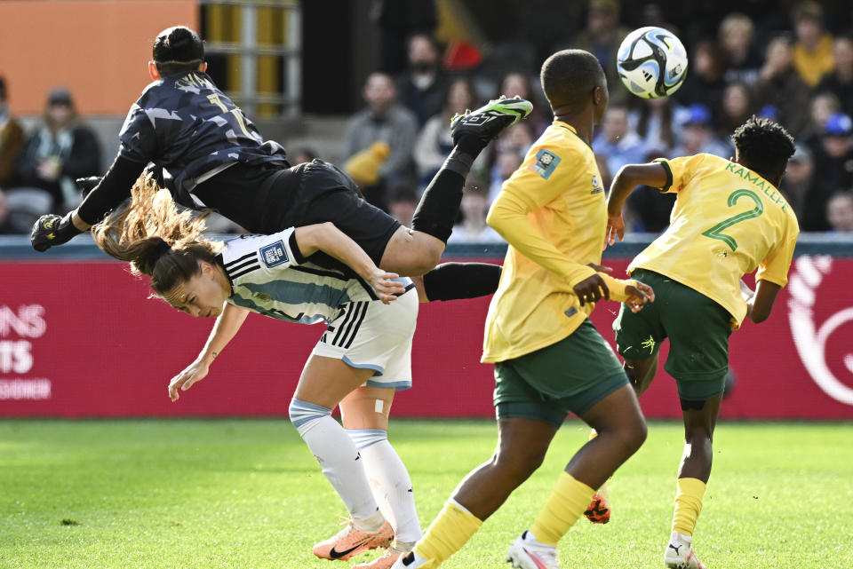 South Africa's goalkeeper Kaylin Swart lands on Argentina's Estefania Banini as she attempts to clear the ball during the Women's World Cup Group G soccer match between Argentina and South Africa in Dunedin, New Zealand, Friday, July 28, 2023. (AP Photo/Andrew Cornaga)