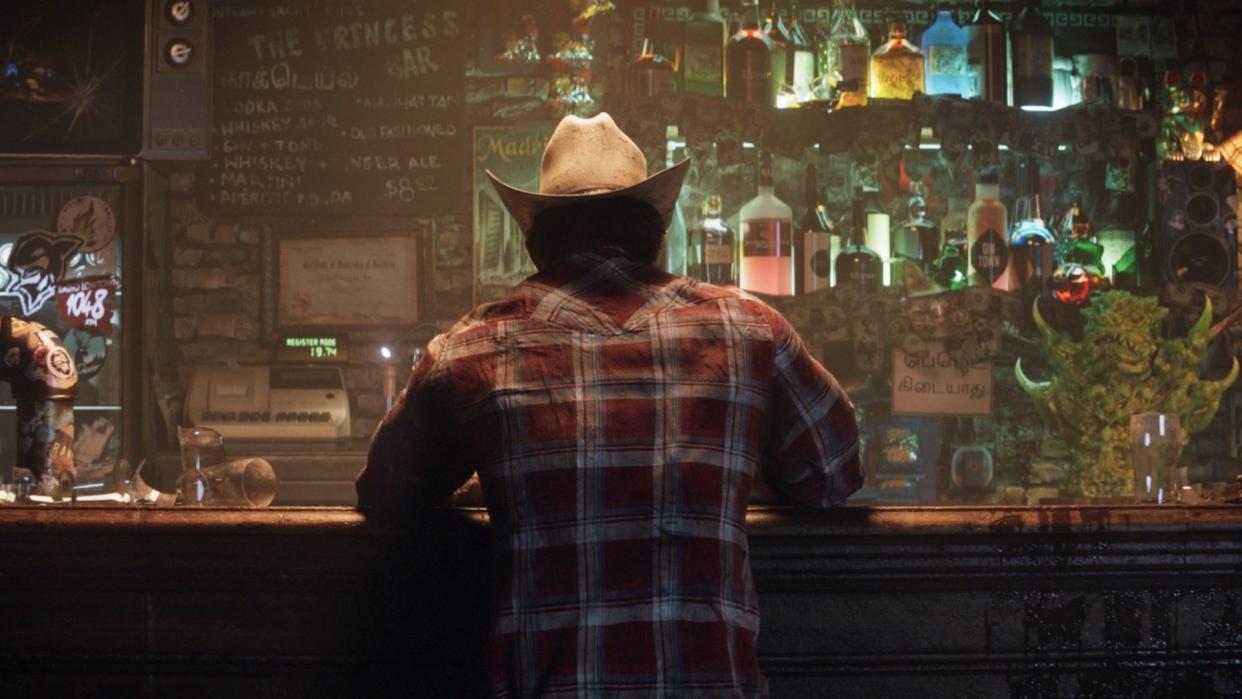  Wolverine sits at a bar with his back to the camera. He's wearing a cowboy hat and a red flannel shirt. 