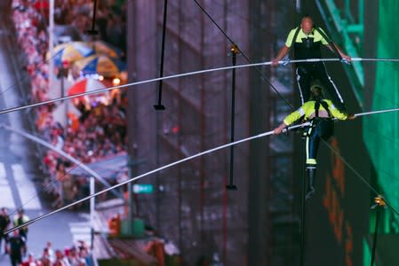 Aerialist Wallenda walks the highwire with his sister Lijana over Times Square in New York