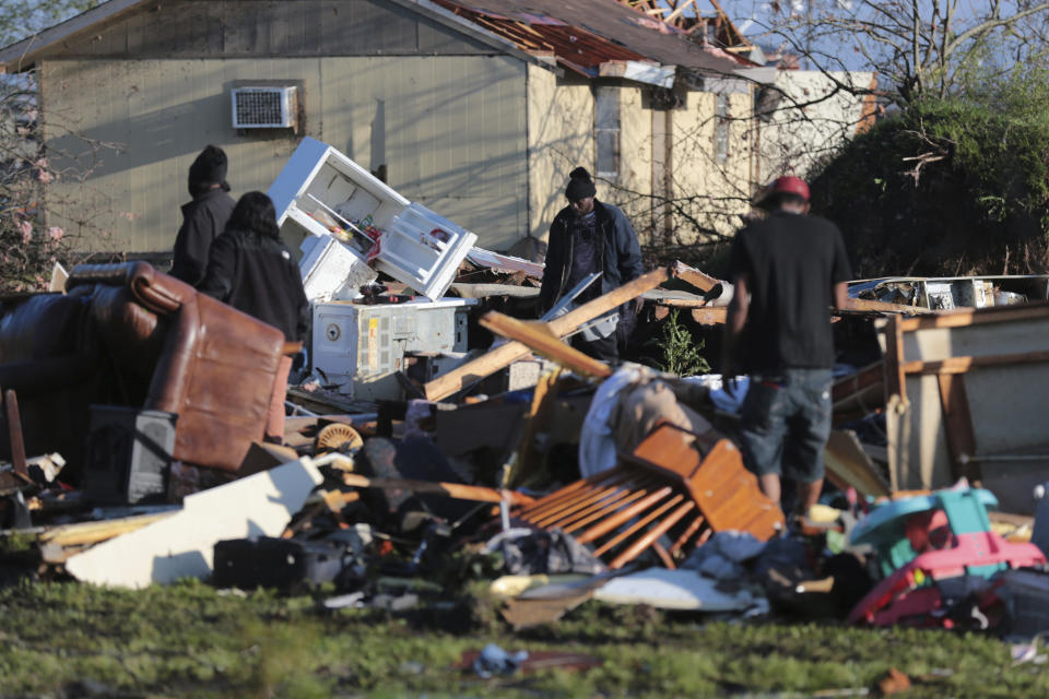 Residents begin going through the debris of a mobile home on D Ave in Amory, Miss., Saturday, March. 25, 2023. Emergency officials in Mississippi say several people have been killed by tornadoes that tore through the state on Friday night, destroying buildings and knocking out power as severe weather produced hail the size of golf balls moved through several southern states. (Thomas Wells/The Northeast Mississippi Daily Journal via AP)