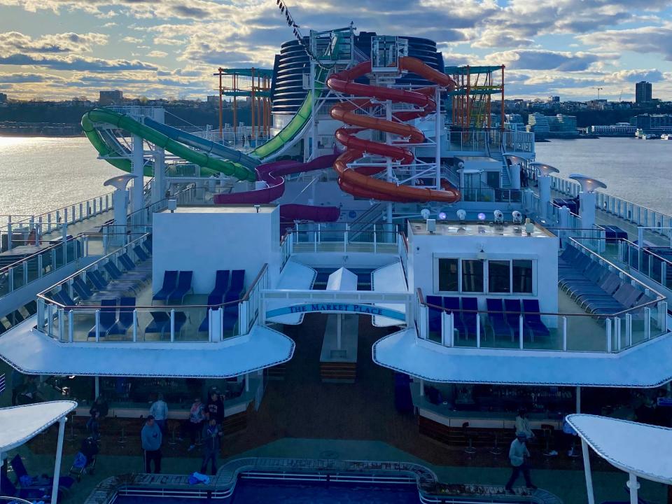 Norwegian Getaway deck, slide in background and pool in foreground