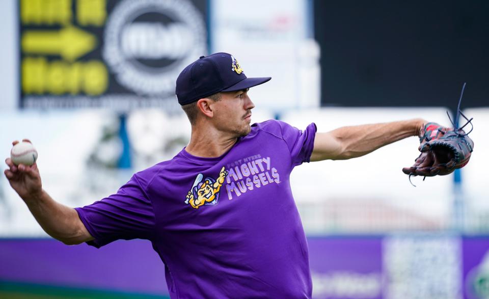 Pitcher Andrew Morris tosses the ball to warm up during a Fort Myers Mighty Mussels practice at Hammond Stadium in Fort Myers on Tuesday, April 4, 2023.