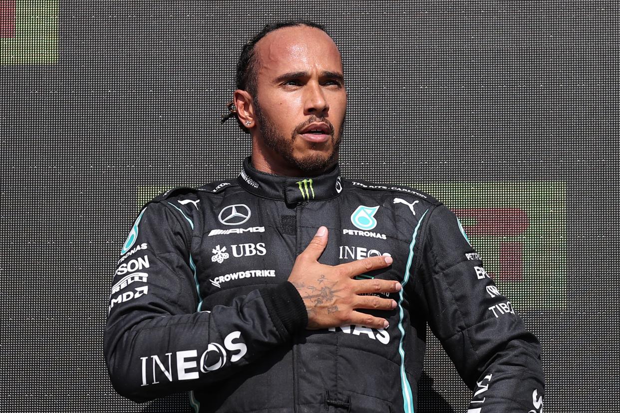 Race winner Mercedes' British driver Lewis Hamilton on the podium after the Formula One British Grand Prix motor race at Silverstone motor racing circuit in Silverstone, central England on July 18, 2021. (Photo by LARS BARON / POOL / AFP) (Photo by LARS BARON/POOL/AFP via Getty Images)