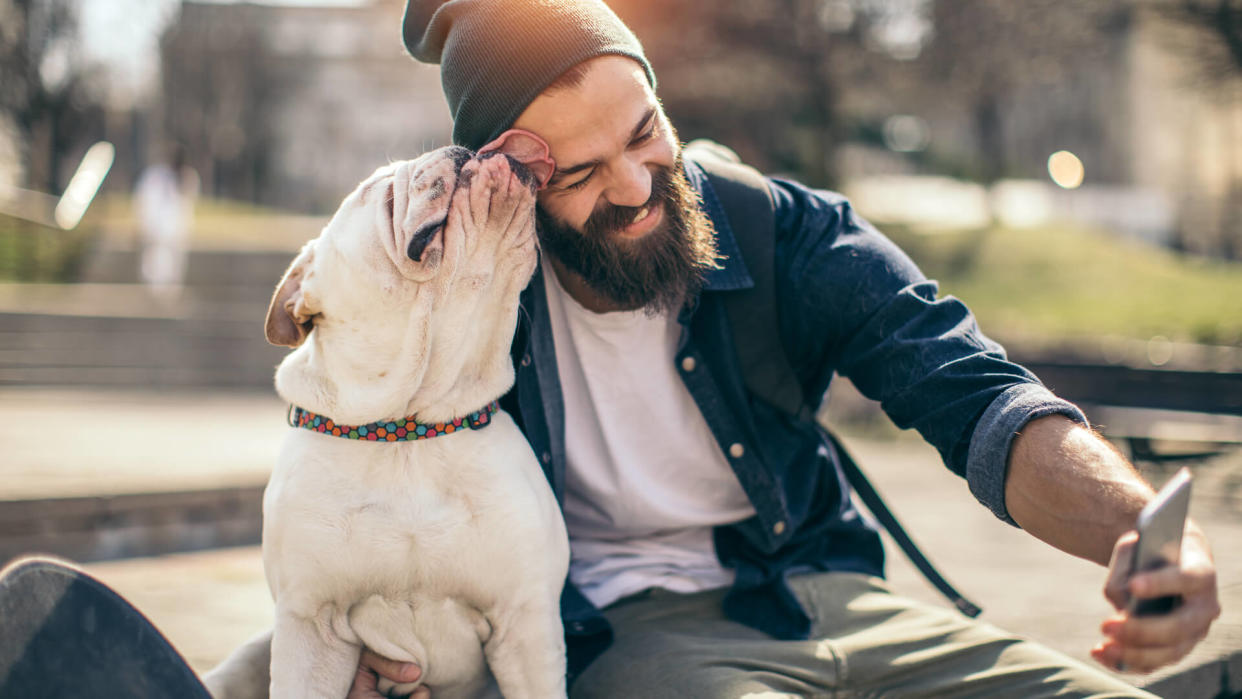 man taking a selfie with his dog