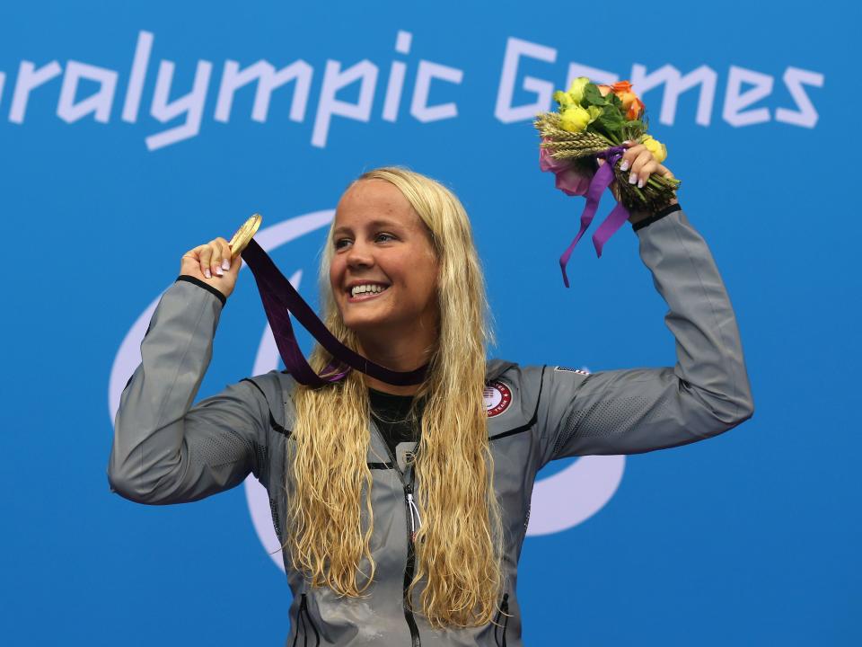 Mallory Weggemann with a gold medal and flowers at the London 2012 Paralympic Games.