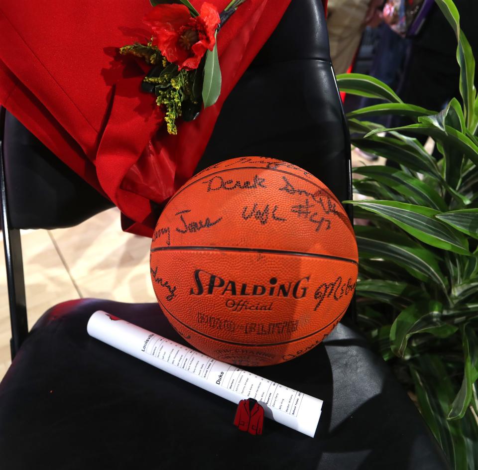 A red jacket and a rolled-up game program were on display at the Denny Crum Celebration of Life on May 15 at the KFC Yum! Center.