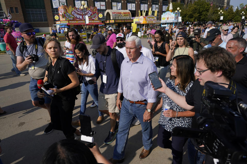 FILE - Republican presidential candidate former Vice President Mike Pence is interviewed as he walks the grand concourse at the Iowa State Fair, Thursday, Aug. 10, 2023, in Des Moines, Iowa. (AP Photo/Charlie Neibergall, File)