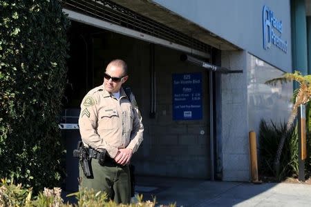 A Sheriffs deputy stands watch outside the opening of a new Planned Parenthood clinic in West Hollywood, California December 1, 2015. REUTERS/David McNew