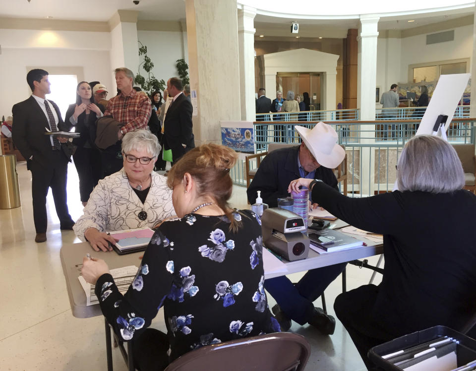 FILE - Rep. Gay Kernan, R-Hobbs, seated at left, and Rep. Bob Wooley, R-Roswell, seated at right, register to run for re-election to the New Mexico Legislature at the Secretary of State's office in Santa Fe, N.M., Tuesday, March 8, 2016. In New Mexico, it's Republicans who contend the Democratic-led Legislature has pushed beyond the will of many voters on abortion policies. (AP Photo/Morgan Lee, File)