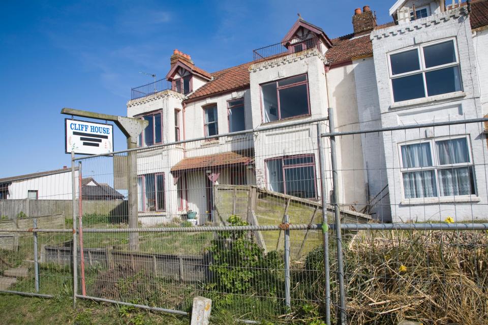 Houses abandoned and derelict awaiting demolition because of coastal erosion, Happisburgh, Norfolk, England