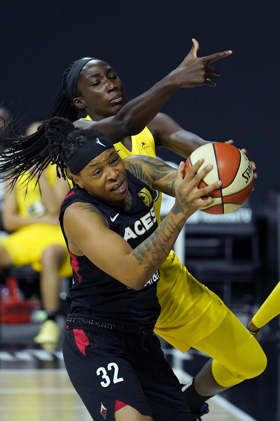 Las Vegas Aces forward Emma Cannon (32) grabs a rebound away from Seattle Storm center Ezi Magbegor (13) during the first half of Game 1 of basketball's WNBA Finals Friday, Oct. 2, 2020, in Bradenton, Fla. (AP Photo/Chris O'Meara)