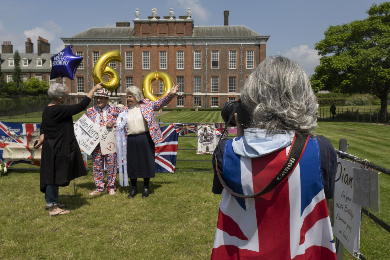 On the day after what would have been the 60th birthday of Princess Diana, people gather to pay their respects, and to lay flowers, pictures and messages at a memorial to her at the gates of Kensington Palace on 2nd July 2021 in London, United Kingdom. Diana, Princess of Wales became known as the Peoples Princess following her tragic death, and now as in 1997, many royalists, and mourners came to her royal residence in remembrance and respect. (photo by Mike Kemp/In Pictures via Getty Images)