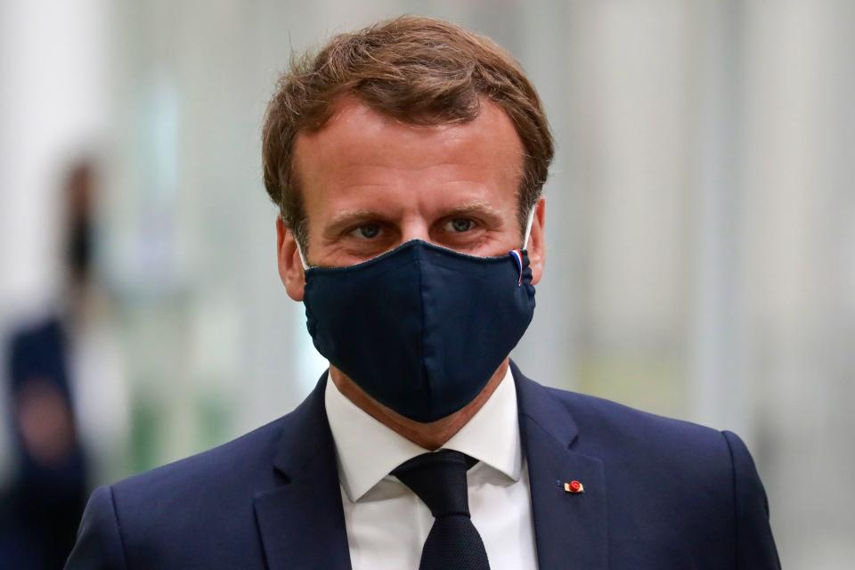 French President Emmanuel Macron, wearing a protective face mask, visits a factory of manufacturer Valeo in Etaples, near Le Touquet, northern France on May 26, 2020 as part of the launch of a plan to rescue the French car industry. (Photo by Ludovic MARIN / POOL / AFP) (Photo by LUDOVIC MARIN/POOL/AFP via Getty Images)