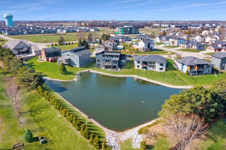 A pond behind the home comes stocked with fish.