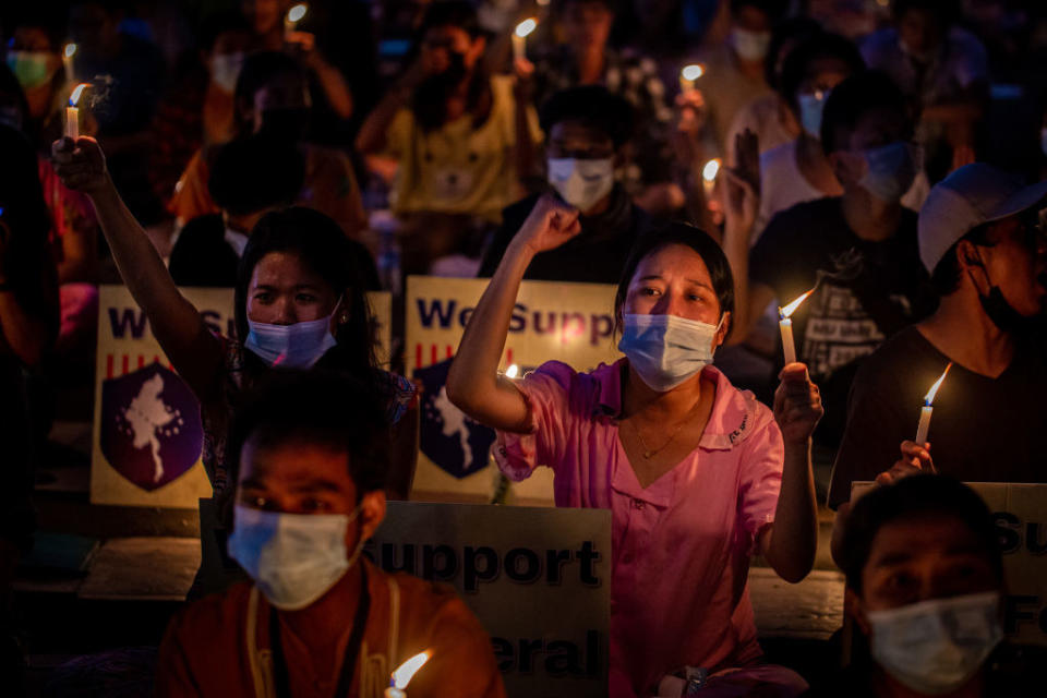 Residents of the Tamwe area protest against the military coup while shouting slogans during a candlelight vigil on April 3, 2021, in Yangon, Myanmar