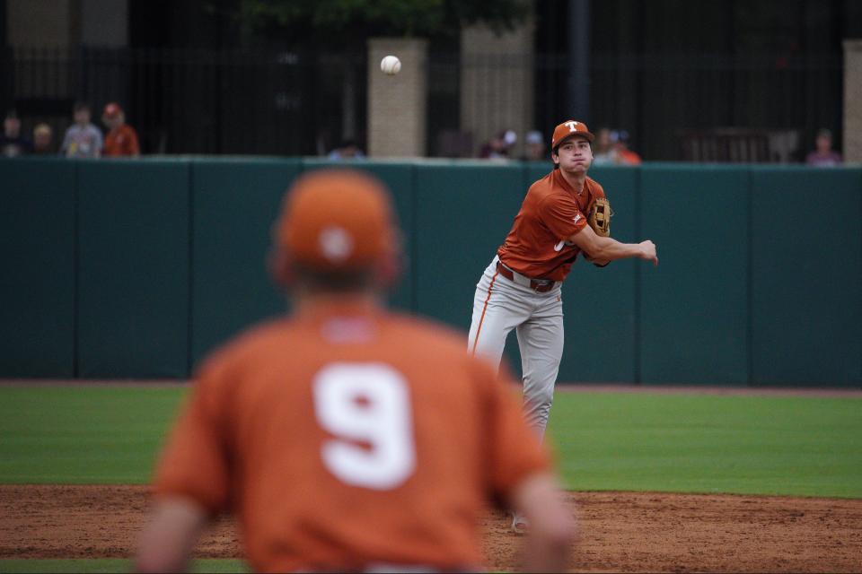 Texas Longhorns infielder Jalin Flores (1) throws to infielder Jared Thomas (9) to force out the Louisiana Ragin Cajuns at first base during the first round in the NCAA baseball College Station Regional May 31, 2024, at Olsen Field in College Station.