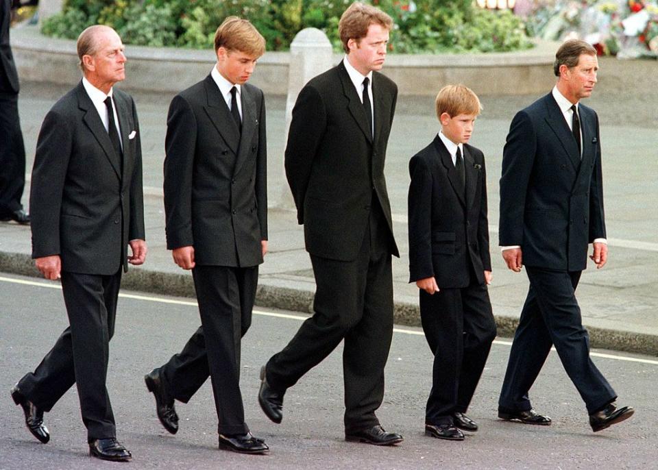 (L to R) The Duke of Edinburgh, Prince William, Earl Spencer, Prince Harry, and Prince Charles walk outside Westminster Abbey during the funeral service for Diana, Princess of Wales, on Sept. 6, 1997. Hundreds of thousands of mourners lined the streets of Central London to watch the funeral procession.<span class="copyright">Jeff J. Mitchell—AFP via Getty Images</span>