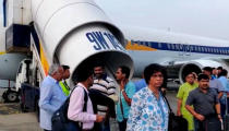 Passengers stand on the tarmac after an emergency landing, due to lost cabin pressure, on a Jet Airways flight, in Mumbai, India September 20, 2018 in this still image obtained from social media video. Melissa Tixiera via REUTERS