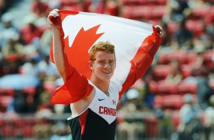 Shawnacy Barber of Canada celebrates with a flag after winning the gold medal in men&#39;s pole vault during the athletics competition at the Pan Am Games in Toronto, Tuesday, July 21, 2015. THE CANADIAN PRESS/Mark Blinch