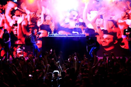 Young people attend electronic music concert with western tunes at closed Hall in Shaab Stadium for the first time in Baghdad