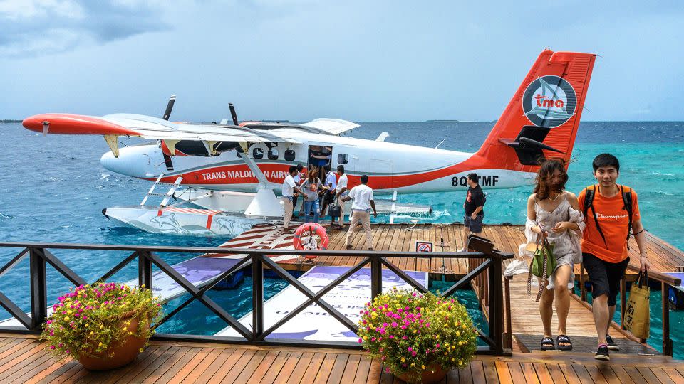 Tourists disembark from a seaplane at a resort in Baa Atoll in Maldives on September 24, 2023. - Mladen Antonov/AFP/Getty Images