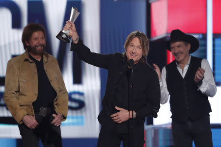 54th Academy of Country Music Awards- Show - Las Vegas, Nevada, U.S., April 7, 2019 - Kix Brooks and Ronnie Dunn of Brooks & Dunn present the entertainer of the year award to Keith Urban. REUTERS/Mario Anzuoni