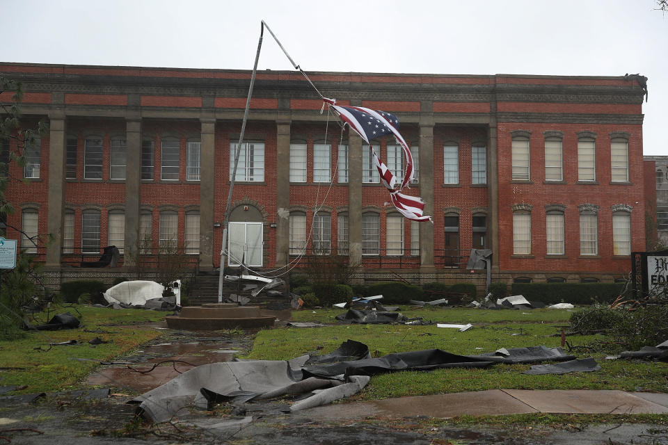 An American flag flies from a broken flag pole after Hurricane Michael passed through the downtown area of Panama City.