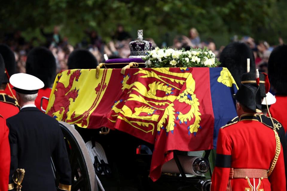The coffin of the Queen, draped in the Royal Standard with the Imperial State Crown placed on top, is carried on a horse-drawn gun carriage of the King’s Troop Royal Horse Artillery during the ceremonial procession from Buckingham Palace to Westminster Hall (Henry Nicholls/PA) (PA Wire)