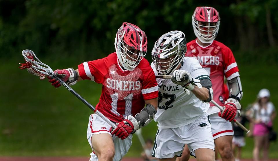 Somers' Mason Kelly (11) works against Pleasantville's Emmet McDermott (22) during boys lacrosse action at Pleasantville High School on Tuesday, May 14, 2024. Pleasantville won 11-10 in overtime.