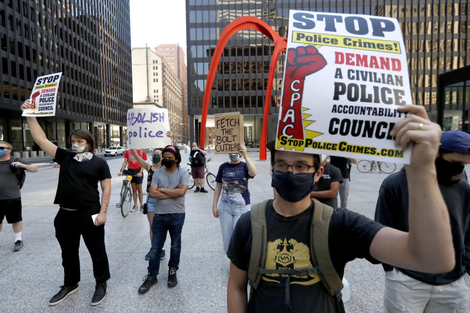 Protesters gather on Federal Plaza Thursday, July 23, 2020, after a collection of Chicago activists groups announced they are filing a federal lawsuit against the Chicago Police Department, Fraternal Order of Police, and the federal government, in Chicago. The lawsuit also asks a judge to prevent agents in Chicago from making arrests or detaining people without probable cause and to require agents to identify themselves and their agency before taking either action and explain why someone is being arrested. (AP Photo/Charles Rex Arbogast)