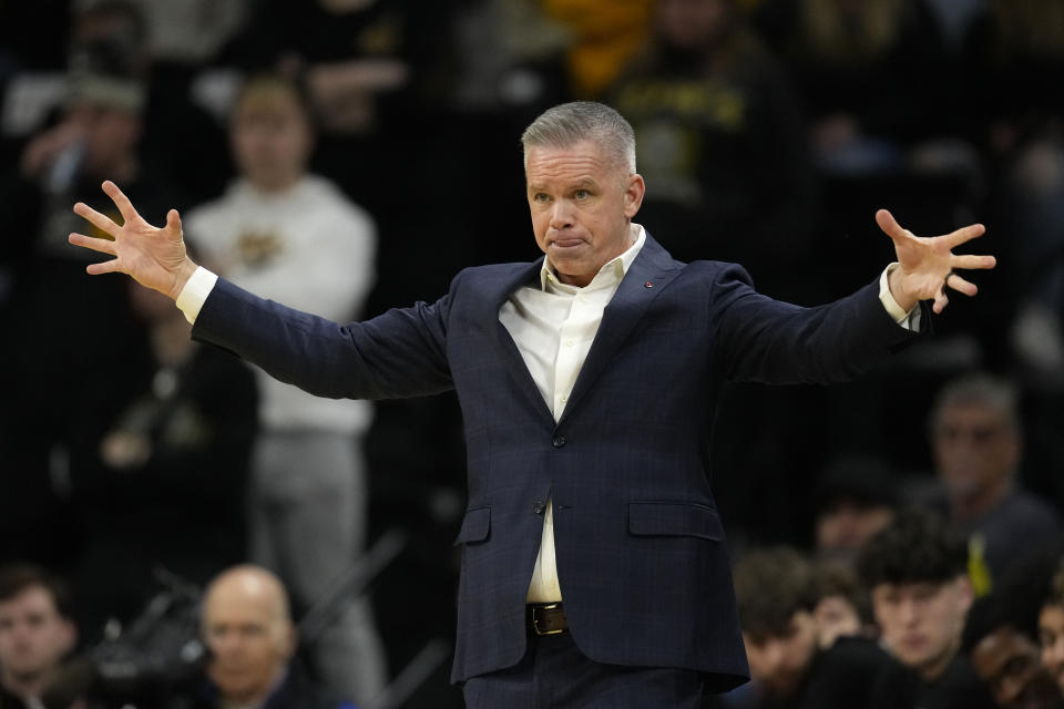 Ohio State head coach Chris Holtmann directs his team during the first half of an NCAA college basketball game against Iowa, Friday, Feb. 2, 2024, in Iowa City, Iowa. (AP Photo/Charlie Neibergall)