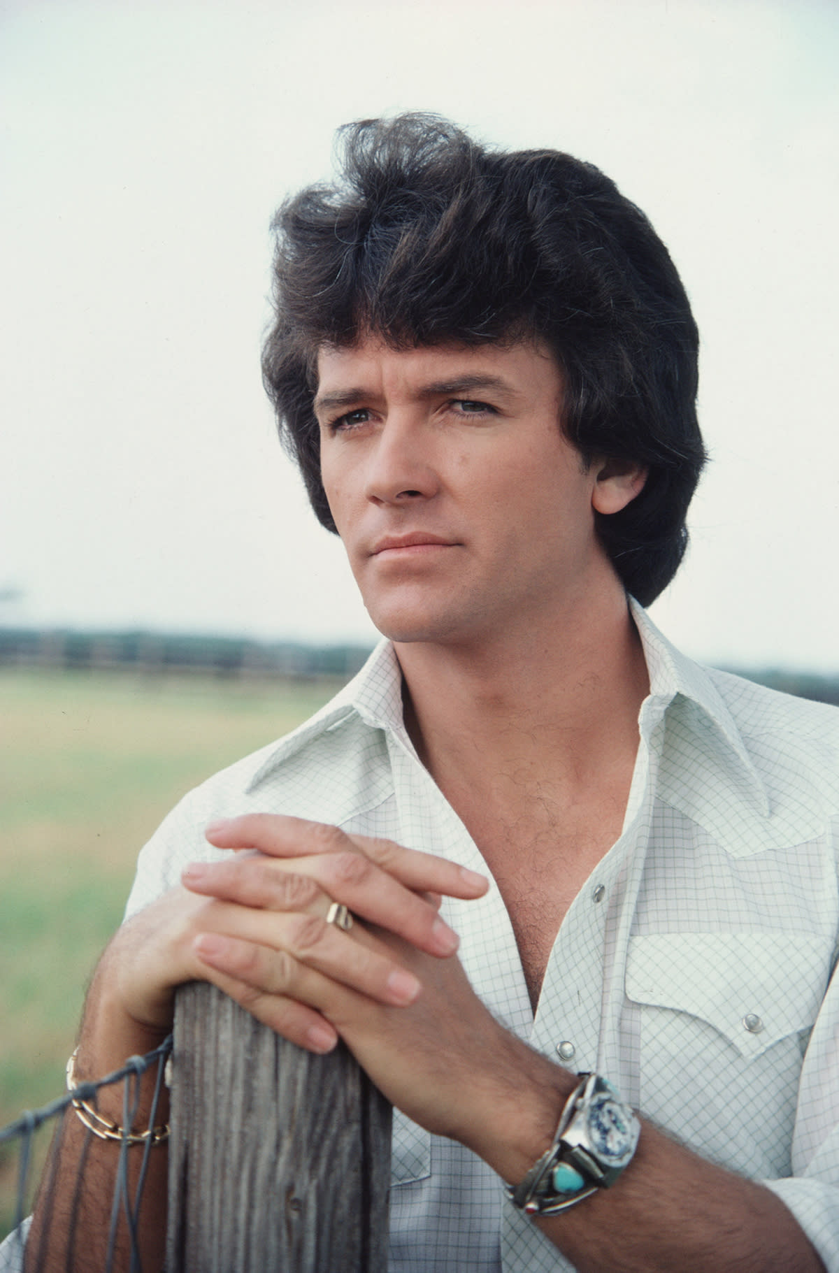 A promotional still from the American television series 'Dallas' shows Patrick Duffy (as Bobby Ewing) as he leans on a fencepost, July 1979. (Photo by CBS Photo Archive/Getty Images) 