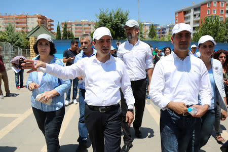 Pro-Kurdish Peoples' Democratic Party (HDP) lawmakers leave from a park after a party meeting in Diyarbakir, Turkey, July 25, 2017. REUTERS/Sertac Kayar