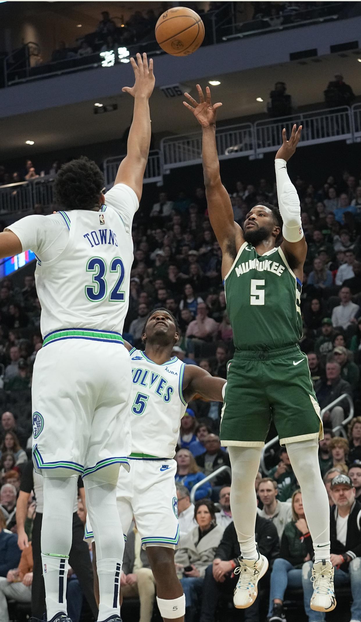 Milwaukee Bucks guard Malik Beasley (5) hits a jump shot over Minnesota Timberwolves center Karl-Anthony Towns (32) during the first half of their game Thursday, February 8, 2024 at Fiserv Forum in Milwaukee, Wisconsin.