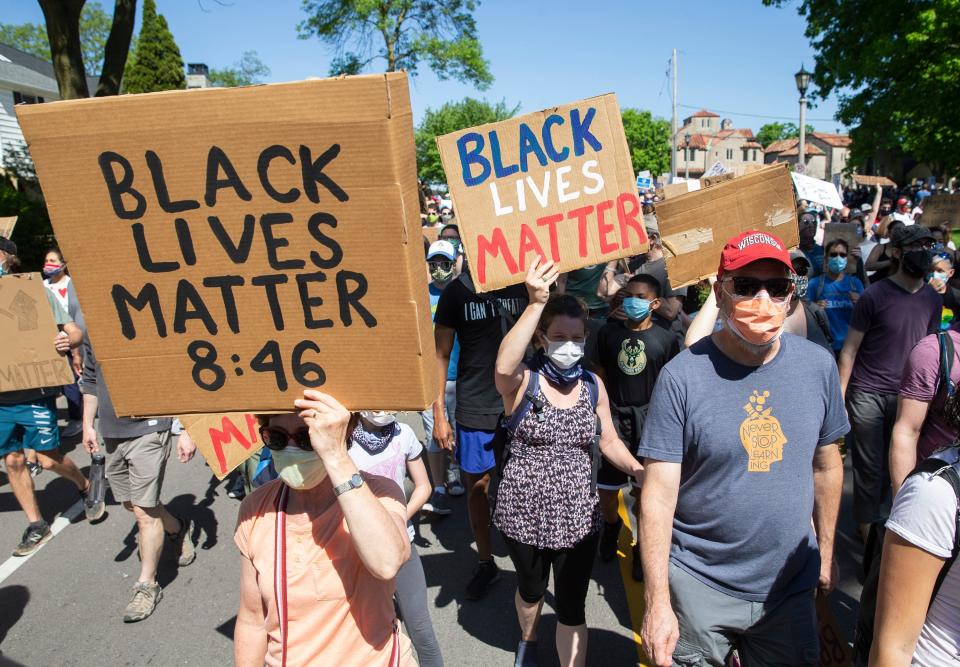 Protesters walk through Shorewood and Whitefish Bay in Milwaukee County, Wisc. to raise awareness of George Floyd and racial justice issues on Saturday, June 6, 2020.