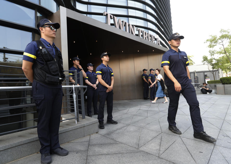 South Korean police officers stand guard against possible rallies against Japan in front of a building where the Japanese embassy is located in Seoul, South Korea, Friday, July 19, 2019. South Korean police say a man has set himself on fire in front of the Japanese Embassy in Seoul amid rising trade disputes between Seoul and Tokyo. (AP Photo/Ahn Young-joon)