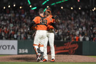 San Francisco Giants catcher Buster Posey (28) celebrates with pitcher Camilo Doval after the Giants defeated the San Diego Padres in a baseball game in San Francisco, Friday, Oct. 1, 2021. (AP Photo/Jeff Chiu)