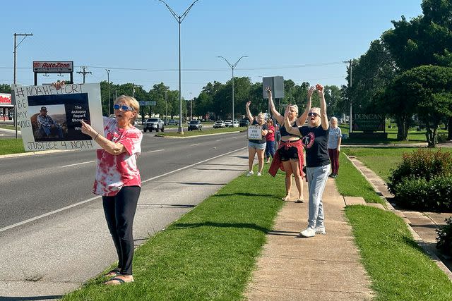 <p>Charlene Belew</p> Prostesters in Dunca, Okla., wave signs drawing on May 15 attention to the death of Noah Presgrove, who was found on the side of Highway 81 near Terral on Sept. 4. His cause of death has been ruled undetermined.