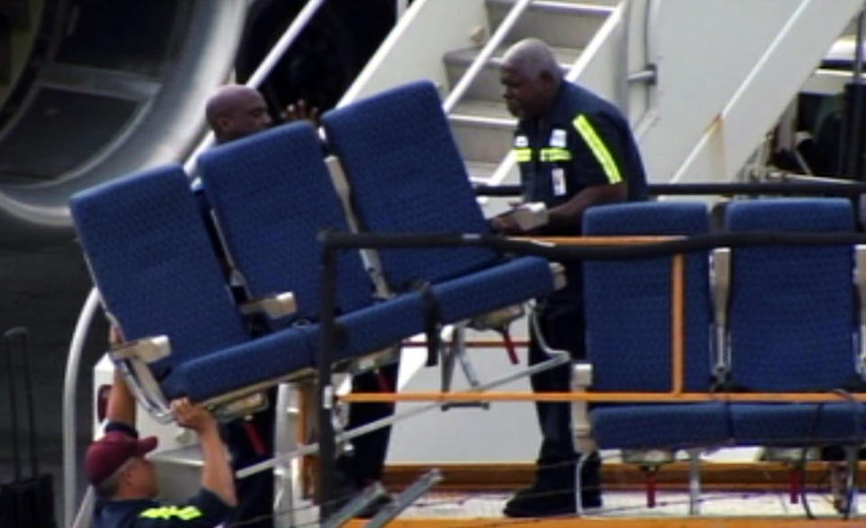 FILE- In this Tuesday, Oct. 2, 2012, file photo provided by WBZ-TV seats from an American Airlines 757 are carried before receiving "Main Cabin Extra Refurbishment", at Logan International Airport in Boston. Just weeks ago, American Airlines was working its way through bankruptcy court, on schedule for one of the fastest turnarounds in aviation history, but then, domestic traffic fell by 7.1 percent in September from the same month a year earlier. No other major airline experienced a drop like that. (AP Photo/WBZ-TV, File) MANDATORY CREDIT